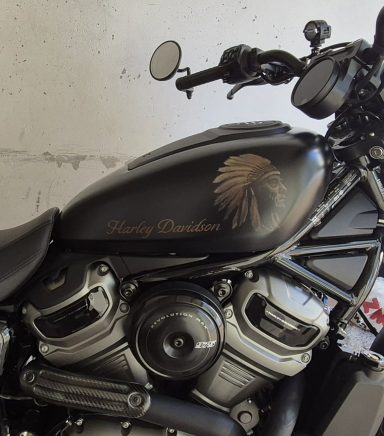 Schwarzes Motorrad mit kunstvollem Indianer-Motiv auf dem Tank.